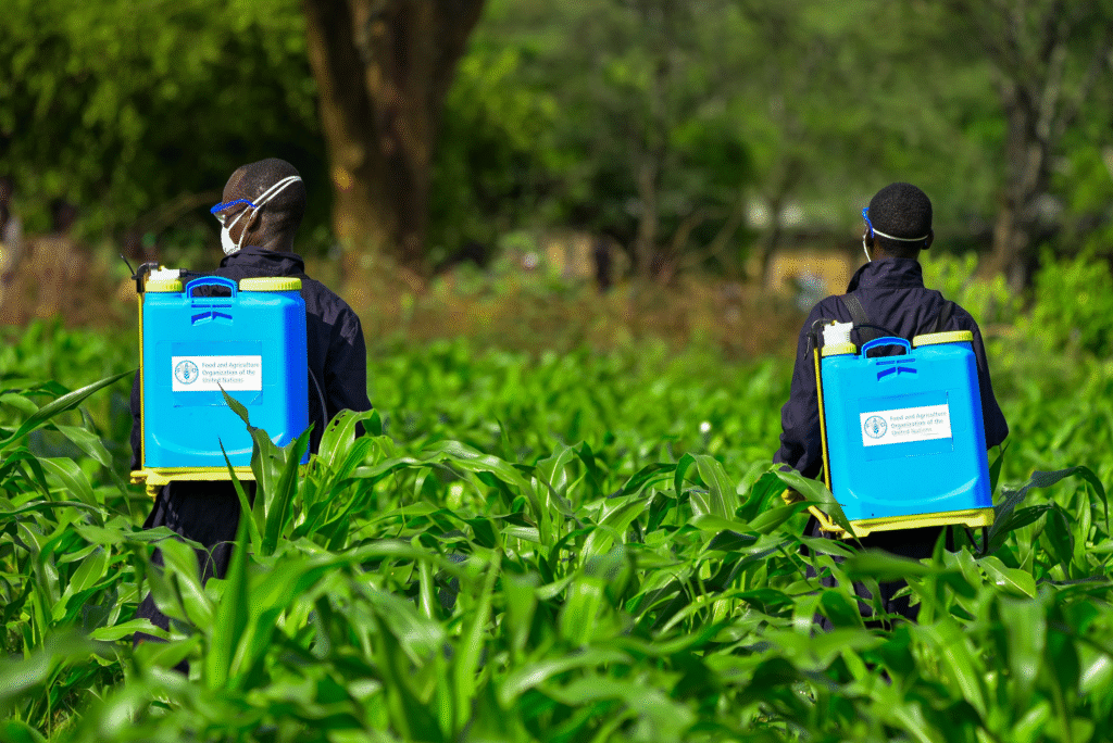DEPARTMENT OF AGRICULTURE "Agricultural worker applying pesticides to protect crops from pests"